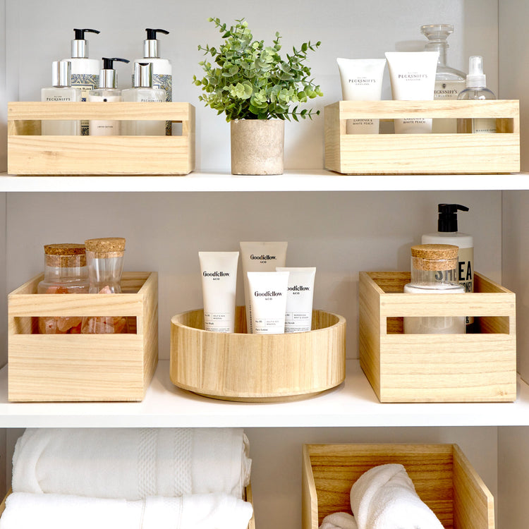 Official iDesign wooden storage bins organizing toiletries on shelving